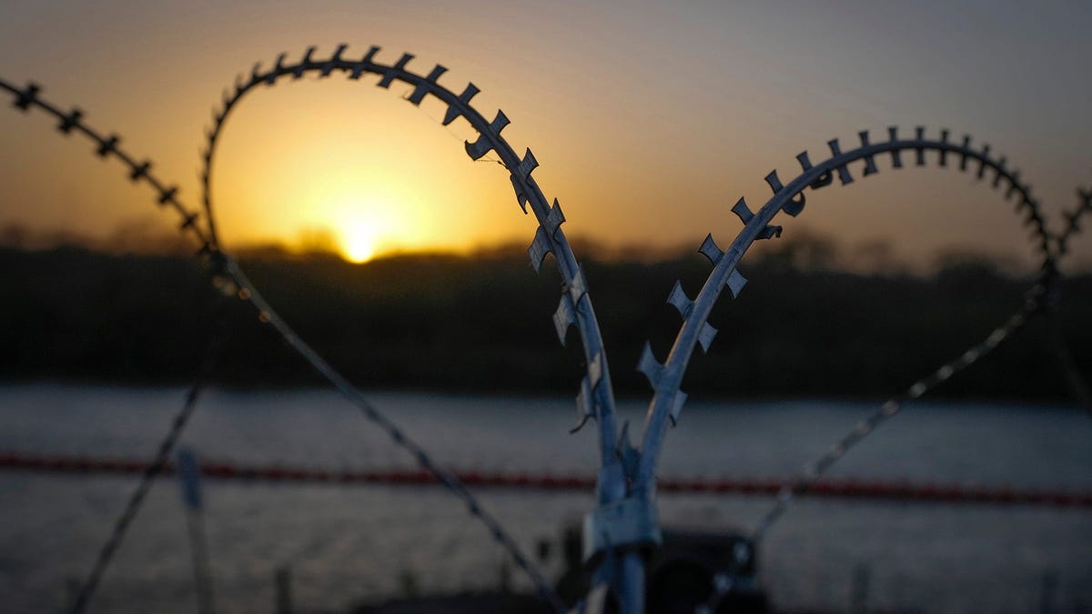 A buoy barrier in the Rio Grande and razor wire protect the U.S. border in Eagle Pass on Monday January 8, 2024.
