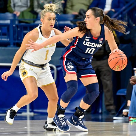 Connecticut guard Nika Muhl (10) dribbles as Notre Dame guard Dara Mabrey (1) defends during their 2023 game at Purcell Pavilion.