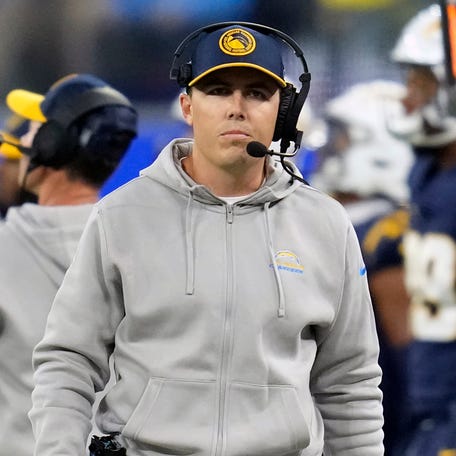 FILE - Los Angeles Chargers offensive coordinator Kellen Moore stands on the sideline during an NFL football game against the Baltimore Ravens, Nov. 27, 2023, in Inglewood, Calif.