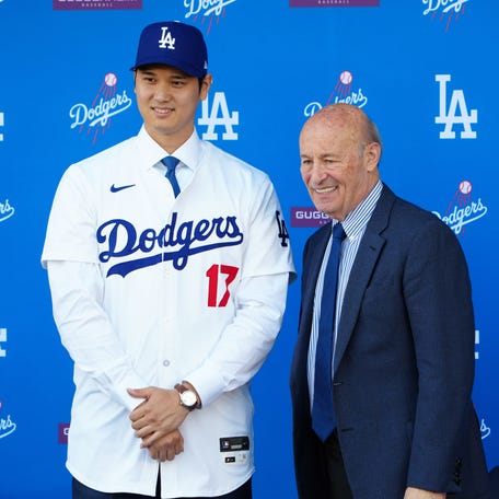 Shohei Ohtani poses with Stan Kasten at his introductory press conference in December.