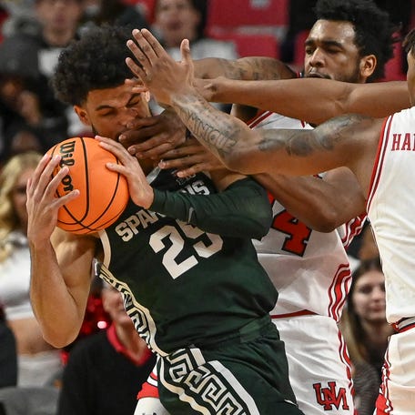 Maryland defenders collapse on Michigan State forward Malik Hall (25) during their game at Xfinity Center.