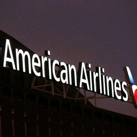 FILE - The American Airlines logo is seen atop the American Airlines Center in Dallas, Dec. 19, 2017. Five flight attendants and one passenger went to a hospital after an American Airlines flight from Los Angeles made a hard landing on Maui, Saturday, Jan. 27, 2024. (AP Photo/Michael Ainsworth, File) ORG XMIT: NYSB702