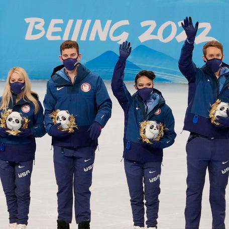 Team USA figure skating team members celebrate during the medal ceremony at the 2022 Beijing Olympic Winter Games at Capital Indoor Stadium.