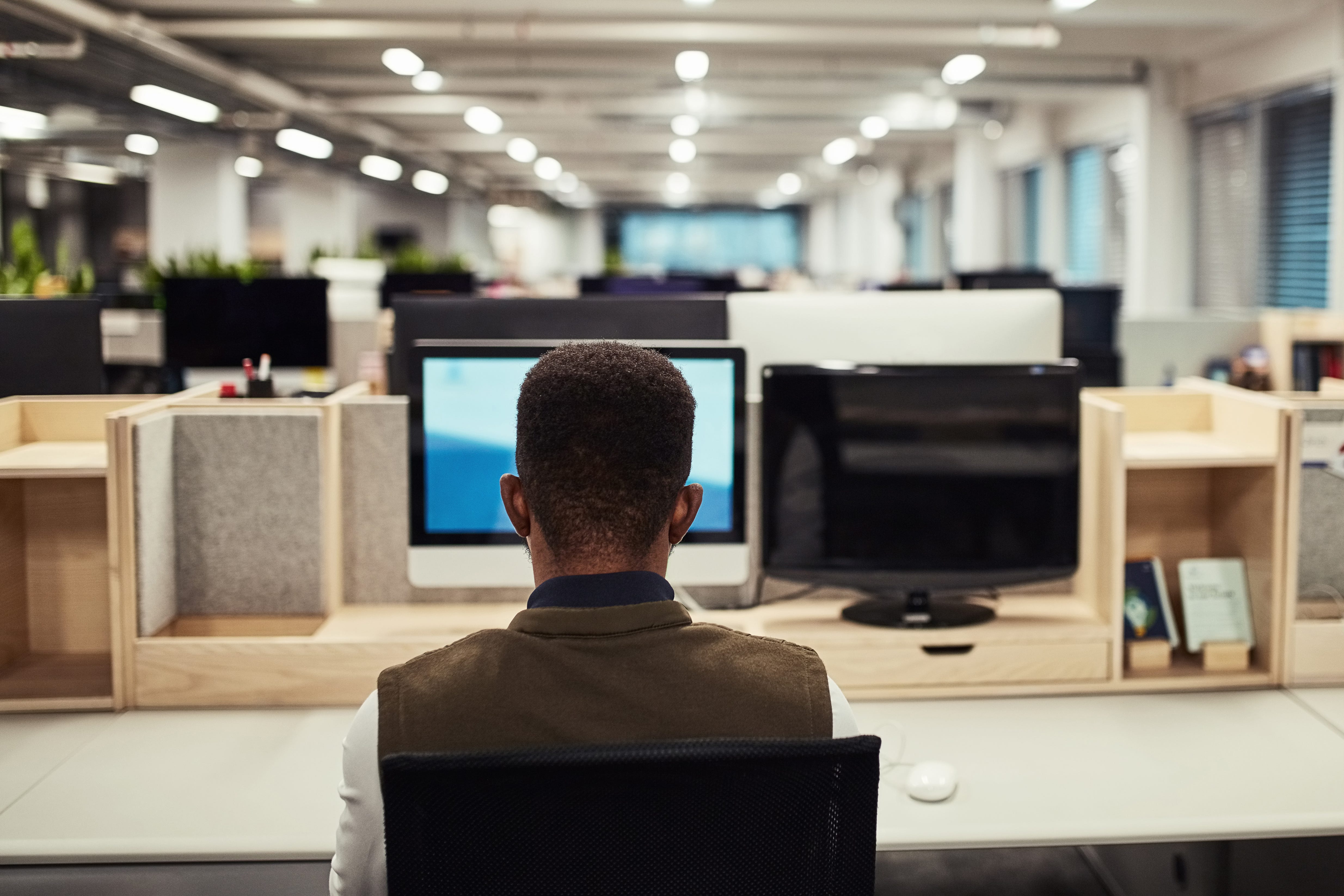 STOCK PHOTO  Rear view shot of a designer working on a computer in an office