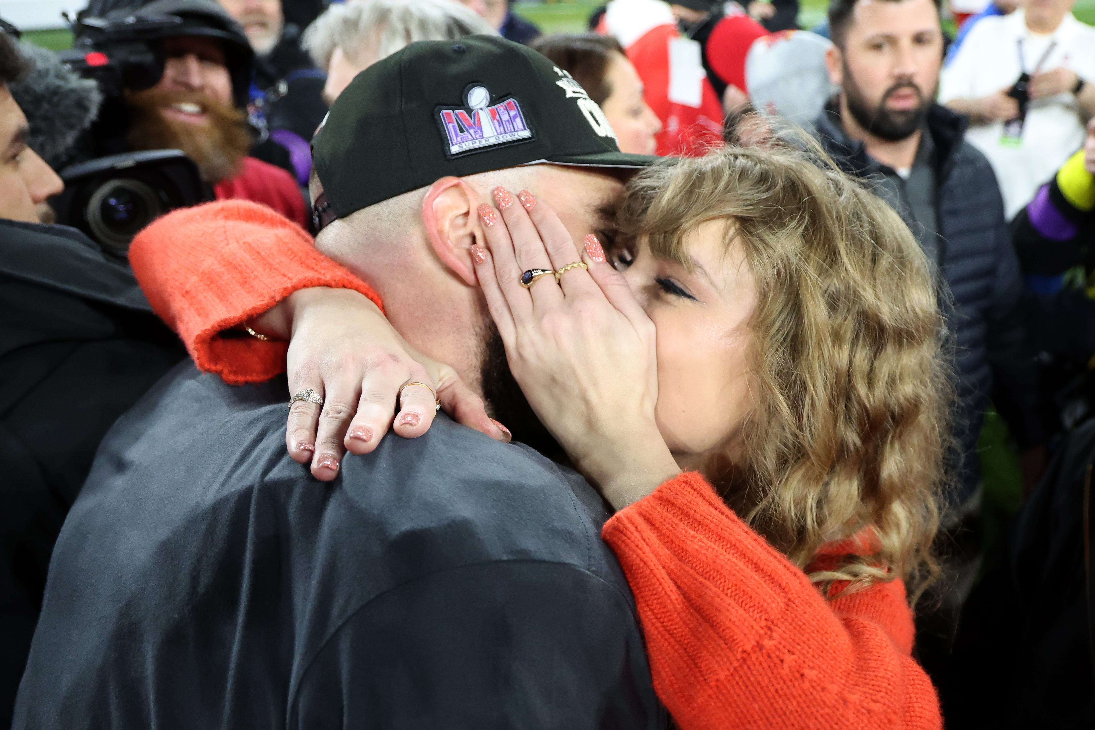 Chiefs tight end Travis Kelce, left, celebrates with Taylor Swift after Kansas City's 17-10 victory against the Ravens in the AFC championship game at M&T Bank Stadium in Baltimore on Jan. 28, 2024.