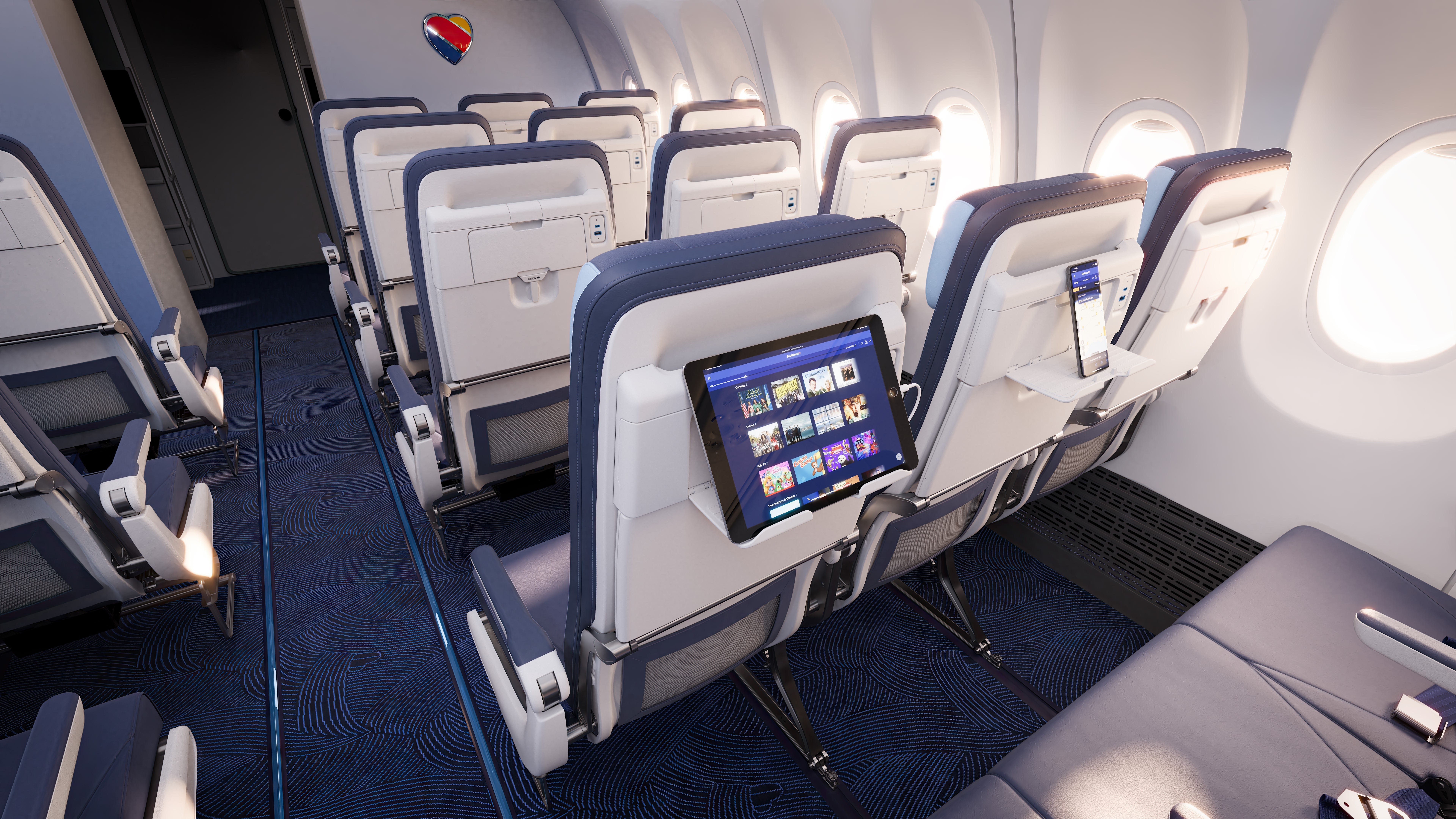 In addition to charging ports, new seats will also feature trays for holding personal electronics.