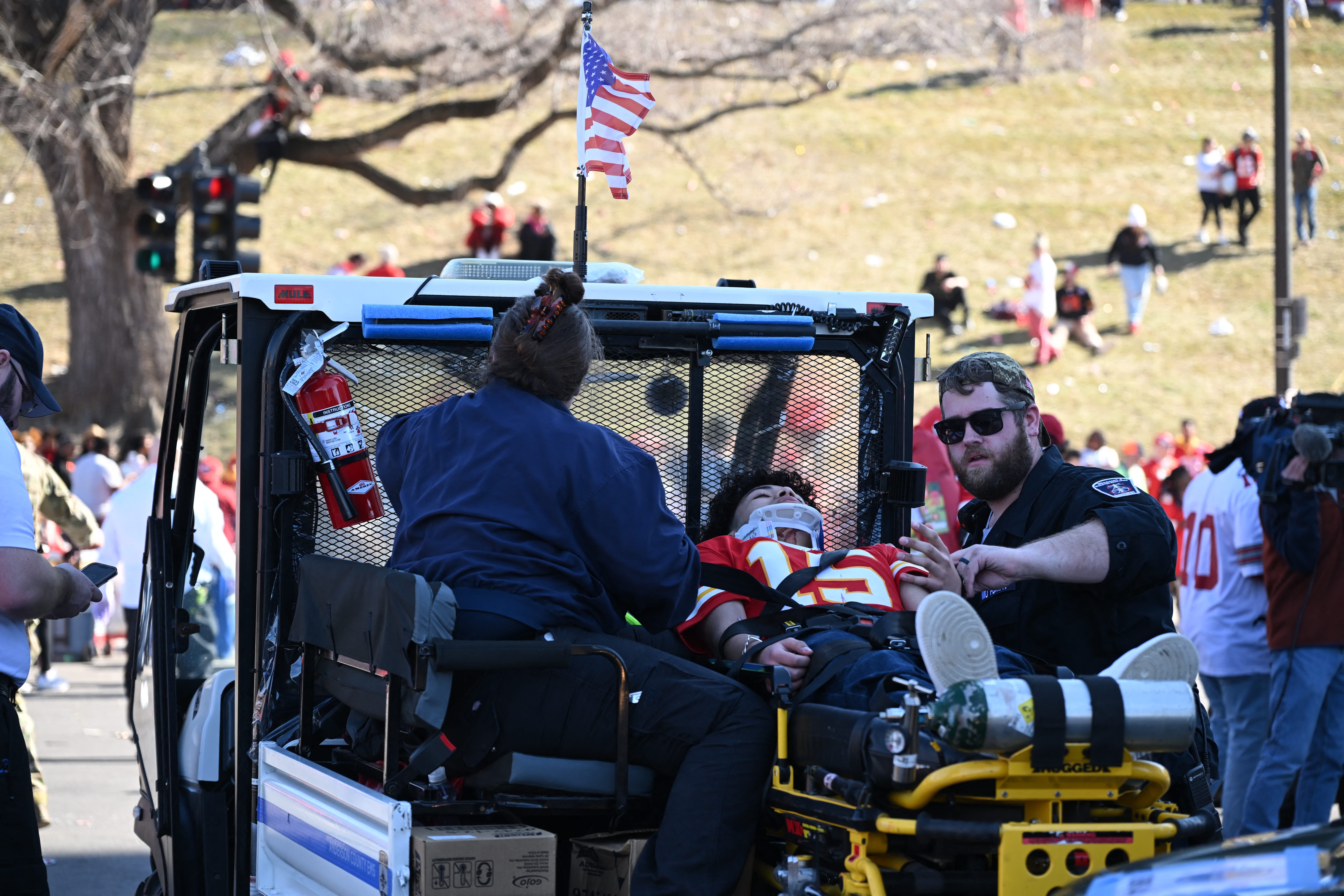 A victim is aided after shots were fired near the Kansas City Chiefs' Super Bowl LVIII victory parade on Feb. 14, 2024, in Kansas City.