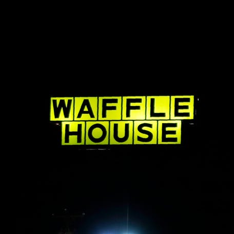 In this file photo, Waffle House, Burger King, and Taco Bell are among the restaurants with lit signs seen along a road at night in Burlington, N.C., Monday, March 9, 2020. Multiple people were shot at a Waffle House in Indianapolis on Monday, Feb. 19, 2024, police told media.