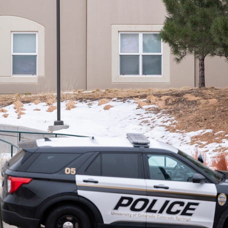 Students look outside their dorm window in the Village at Alpine Valley housing, Friday, Feb. 16, 2024, as police investigate a shooting on the University of Colorado Colorado Springs campus in Colorado Springs, Colo. (Christian Murdock/The Gazette via AP) ORG XMIT: COCOL533