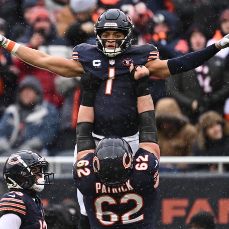 Chicago Bears quarterback Justin Fields (1) celebrates with offensive lineman Lucas Patrick (62) after running for a 9-yard touchdown in the first half against the Atlanta Falcons at Soldier Field.