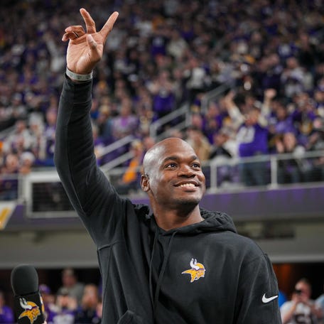 Adrian Peterson salutes the crowd during a 2023 Vikings game.