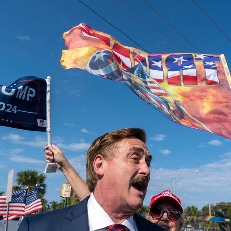 Mike Lindell, the My Pillow Inc chief executive greets Trump supporters as they wait along the motorcade route for former President Donald Trump to return home to Mar-a Lago following his arraignment in New York on April 4, 2023.