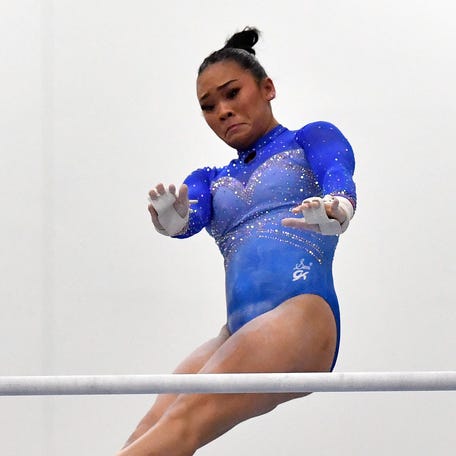 Suni Lee performs on the uneven bars at the USA Gymnastics Winter Cup competition.