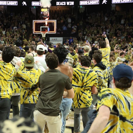 Wake Forest fans storm the court after Saturday's upset against Duke.