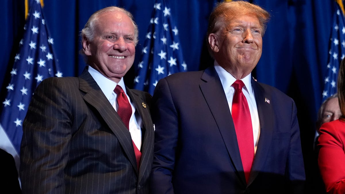Republican presidential candidate former President Donald Trump stands on stage with South Carolina Gov. Henry McMaster at a primary election night party at the South Carolina State Fairgrounds in Columbia, S.C., Saturday, Feb. 24, 2024. (AP Photo/Andrew Harnik)