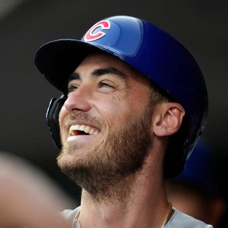 Chicago Cubs center fielder Cody Bellinger celebrates in the dugout after hitting a solo home run during a 2023 game against the Cincinnati Reds at Great American Ball Park.