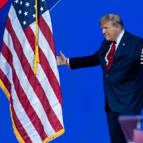Republican presidential candidate former President Donald Trump walks to kiss the American flag before speaking during the Conservative Political Action Conference, CPAC 2024, at the National Harbor, in Oxon Hill, Md., on Feb. 24, 2024.
