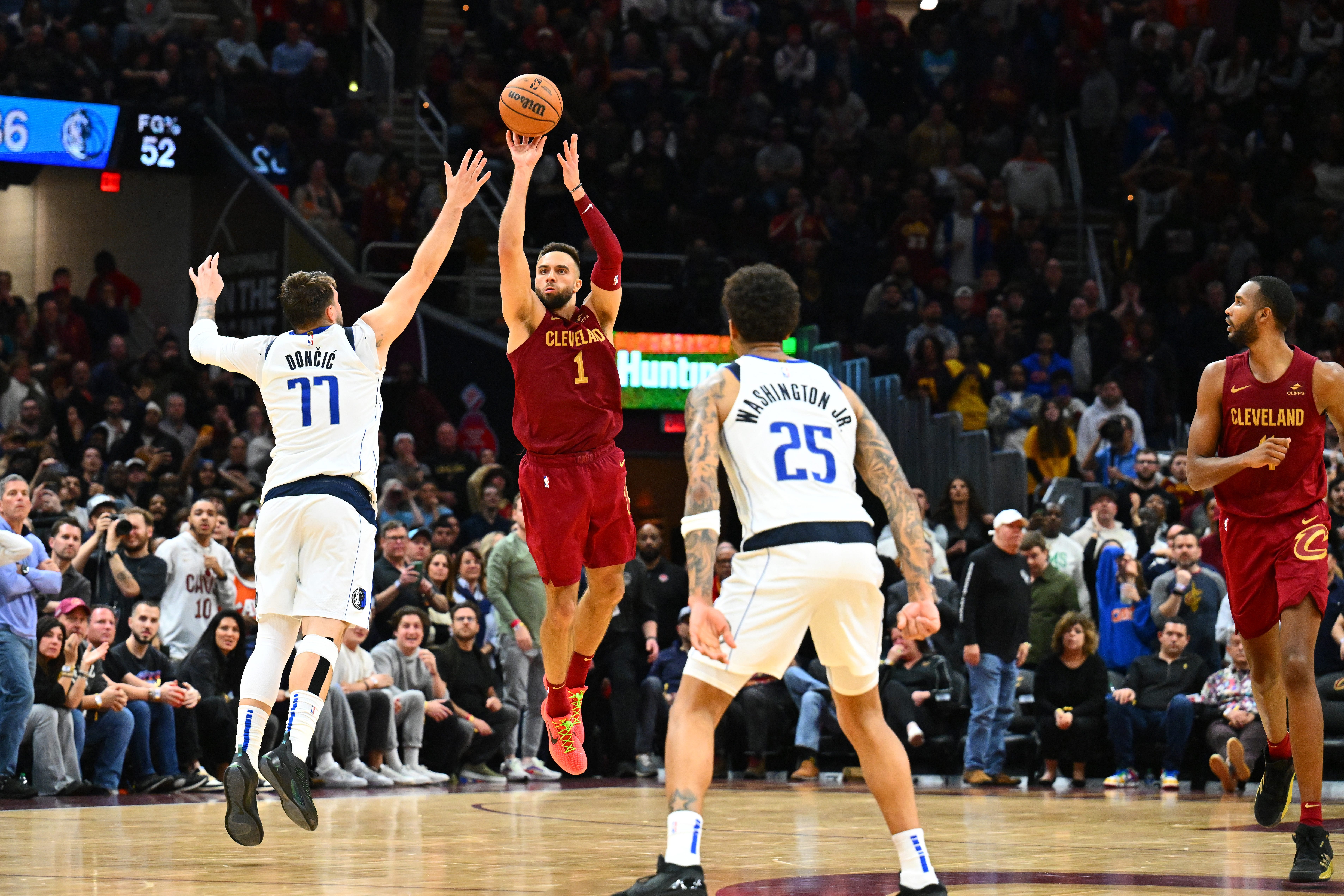 CLEVELAND, OHIO - FEBRUARY 27: Max Strus #1 of the Cleveland Cavaliers shoots a half-court shot over Luka Doncic #77 of the Dallas Mavericks to defeat the Mavericks in the last second of the fourth quarter. (Photo by Jason Miller/Getty Images)