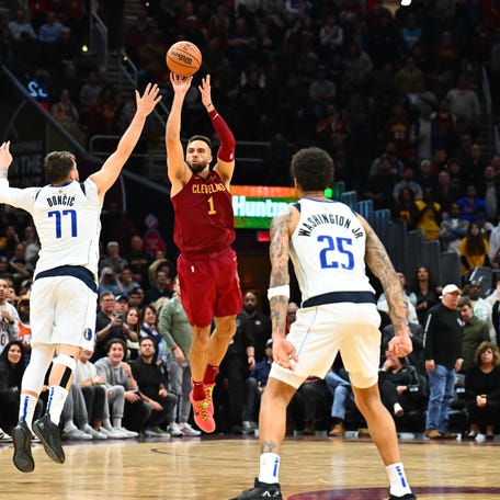 CLEVELAND, OHIO - FEBRUARY 27: Max Strus #1 of the Cleveland Cavaliers shoots a half-court shot over Luka Doncic #77 of the Dallas Mavericks to defeat the Mavericks in the last second of the fourth quarter. (Photo by Jason Miller/Getty Images)