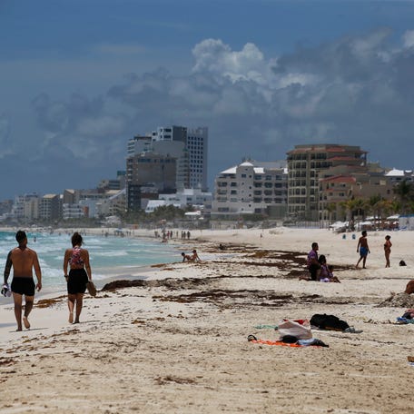 Tourists enjoy the beach in Cancun, Quintana Roo State, Mexico, Wednesday, Aug. 18, 2021.