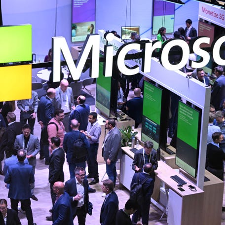 People visit Microsoft's stand during the Mobile World Congress (MWC), the telecom industry's biggest annual gathering, in Barcelona on February 26, 2024.