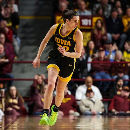 Iowa guard Caitlin Clark jogs up the court after hitting a 3-pointer against Minnesota.