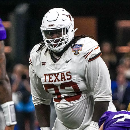 Texas Longhorns defensive lineman T'Vondre Sweat (93) watches Washington quarterback Michael Penix Jr. (9) before a snap during the Sugar Bowl College Football Playoff semifinals game at the Caesars Superdome on Monday, Jan. 1, 2024 in New Orleans, Louisiana.