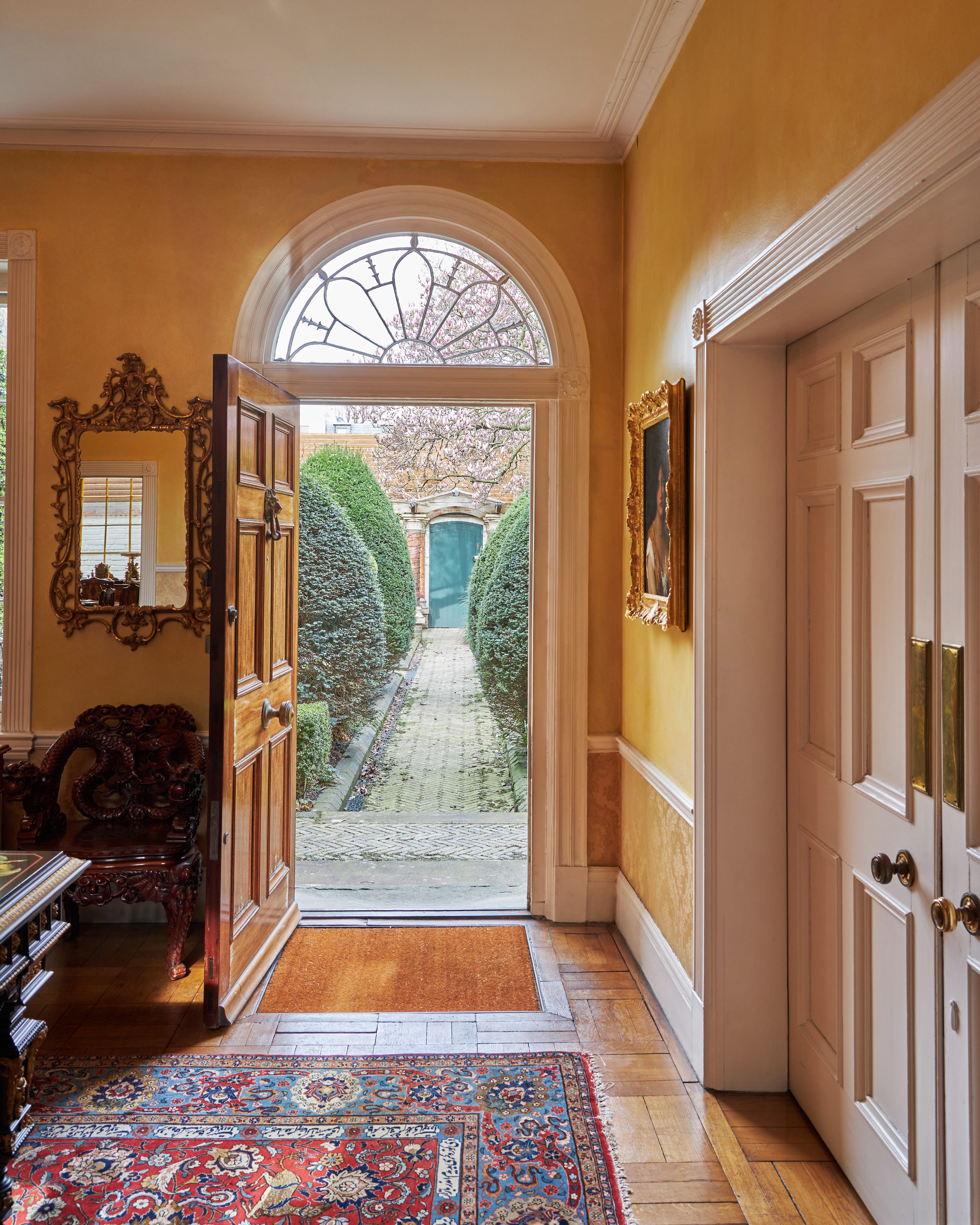 View from the hall of the Garden Lodge looking towards the famous 'Green Door,' the portal to Freddie Mercury's home in Kensington. In a 2023 auction for the Queen singer's belongings, the door adorned with graffitied notes of admiration sold for $521,000.