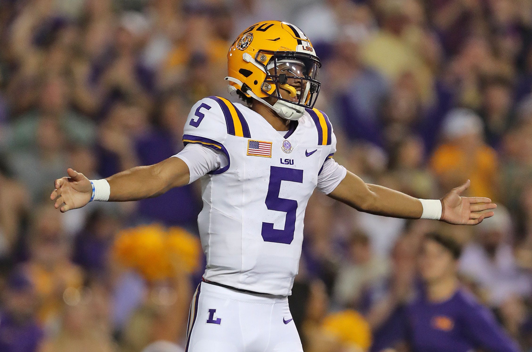Oct 21, 2023; Baton Rouge, Louisiana, USA; LSU Tigers quarterback Jayden Daniels (5) celebrates a touchdown against the Army Black Knights during the first half at Tiger Stadium. Mandatory Credit: Danny Wild-USA TODAY Sports ORG XMIT: IMAGN-712311 ORIG FILE ID: 20231021_tbs_bw1_339.JPG