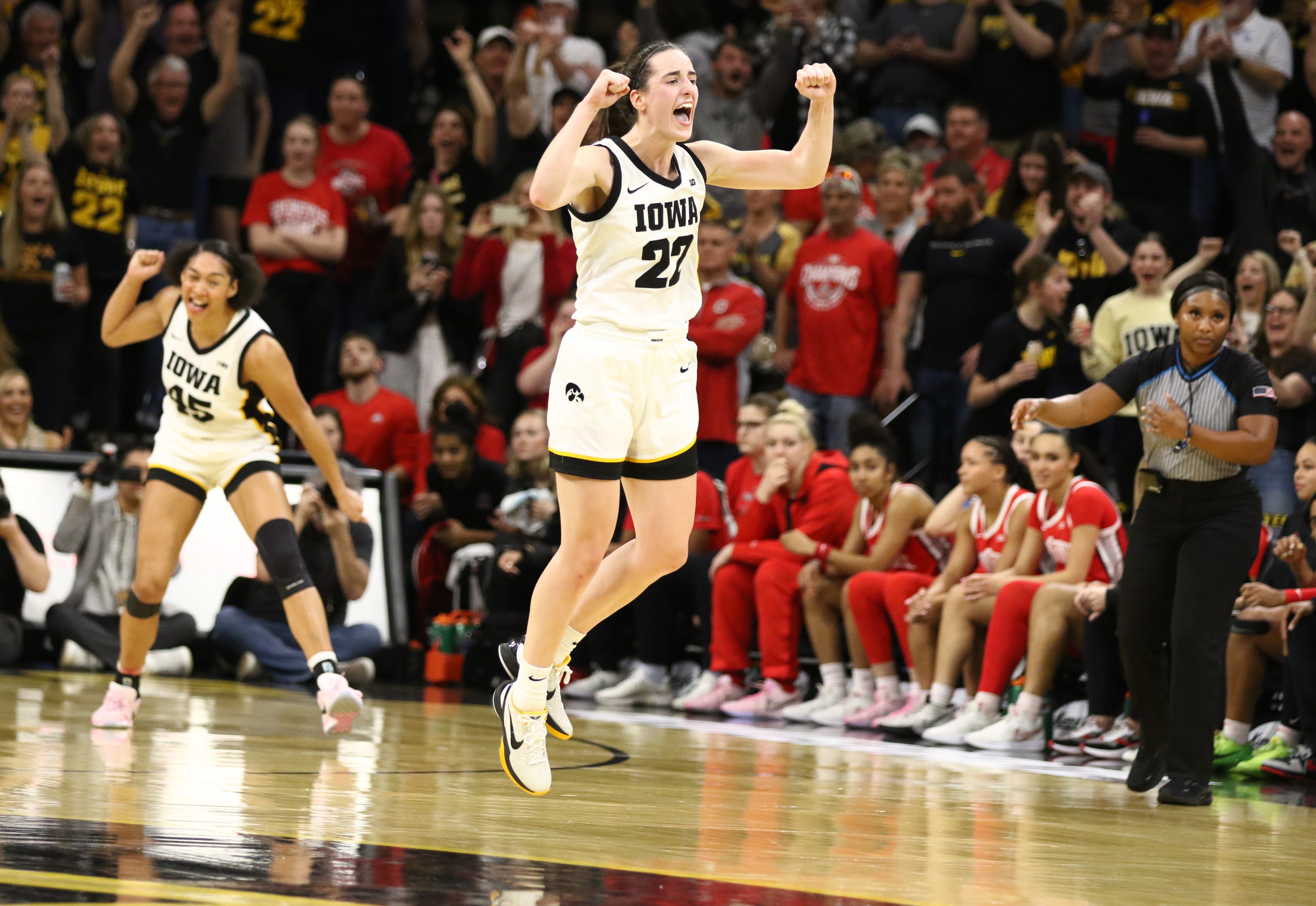 Caitlin Clark celebrates after breaking Pete Maravich's record as college basketball's all-time leading scorer.