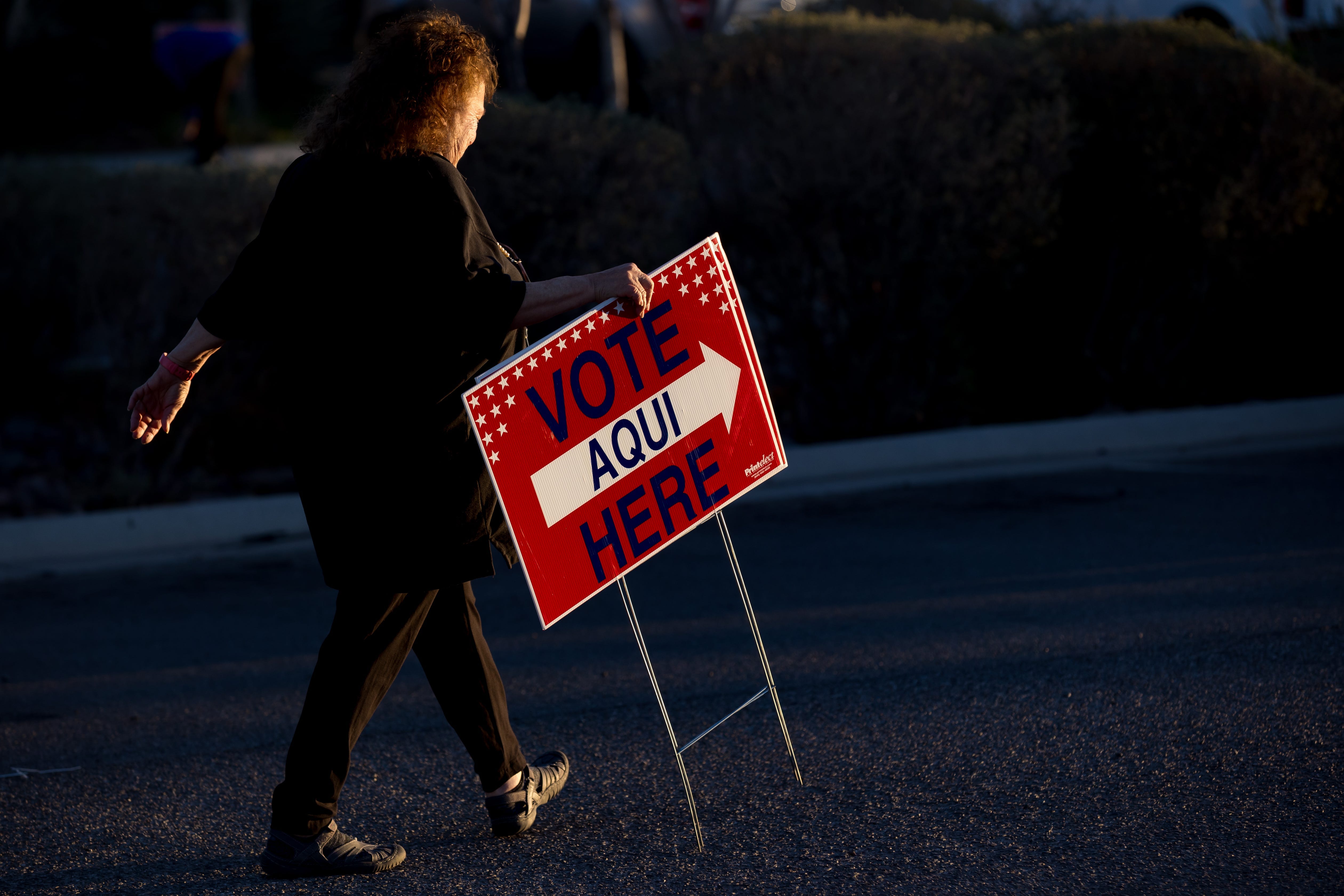 A ÓVote HereÓ sign is put up by an Election Official outside the El Paso County Tax Office- Eastside Annex voting polls in El Paso during Primary Election Day in Texas.