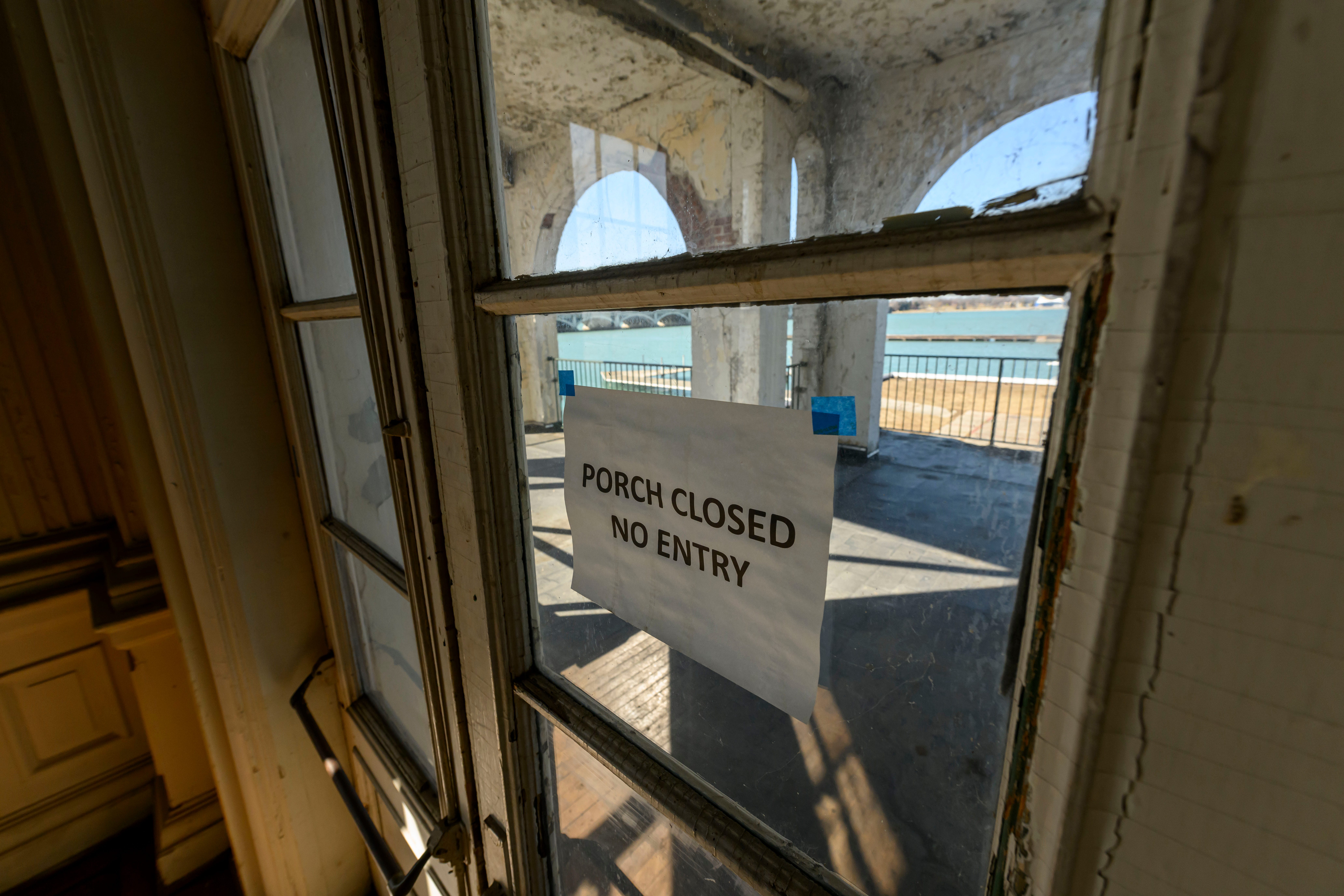 A porch closed due to damage can be seen through the windows of the Detroit Boat Club, on Belle Isle, February 29, 2024. Deemed structurally unsound since 2022, preservationists have led a successful effort to make the DNR, which operates Belle Isle, to attempt to restore the boathouse instead of demolishing it.