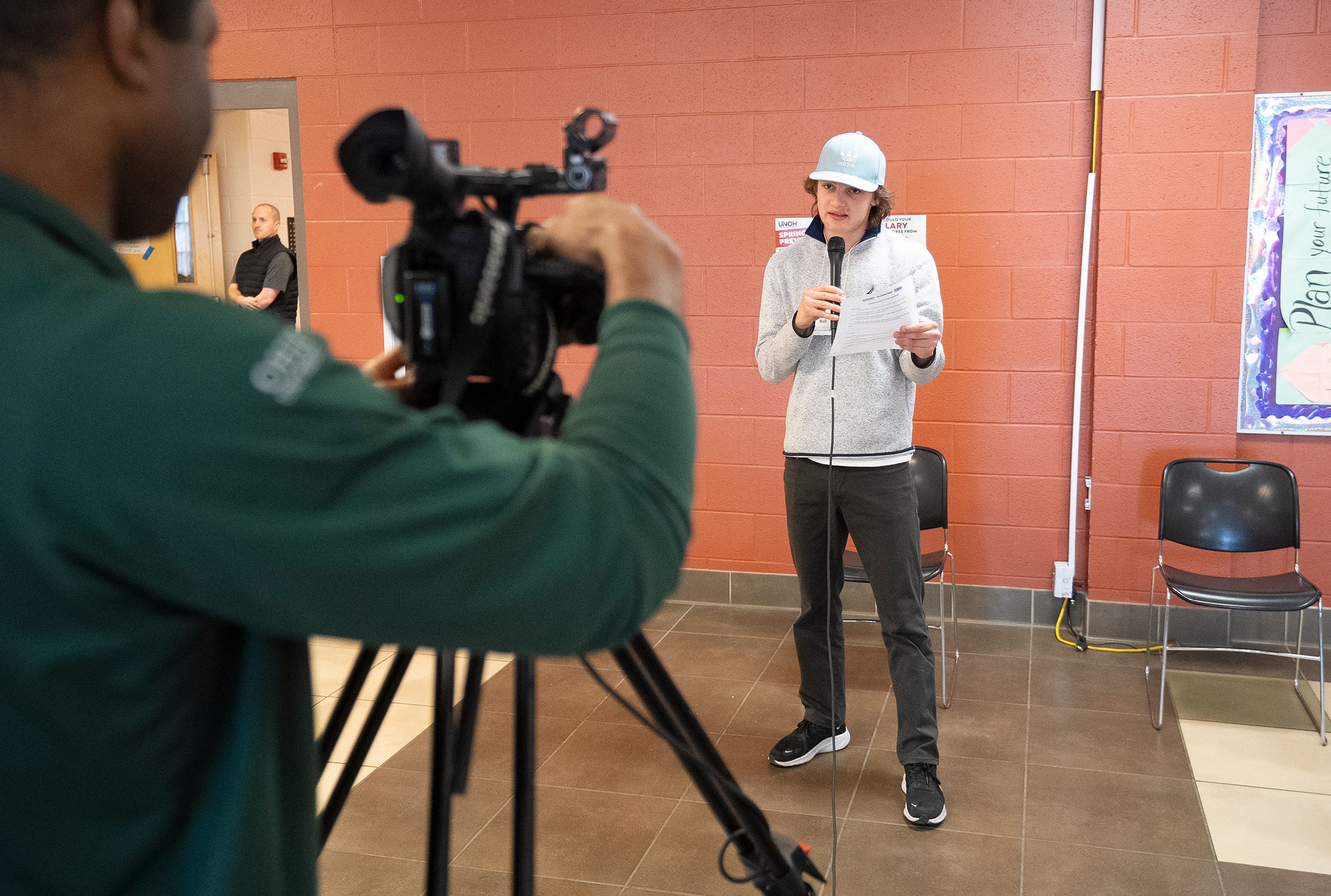 Matt Barnes helps Oscar Ball train on how to talk while on camera during the Columbus Journalist in Training class on February 17, 2024.