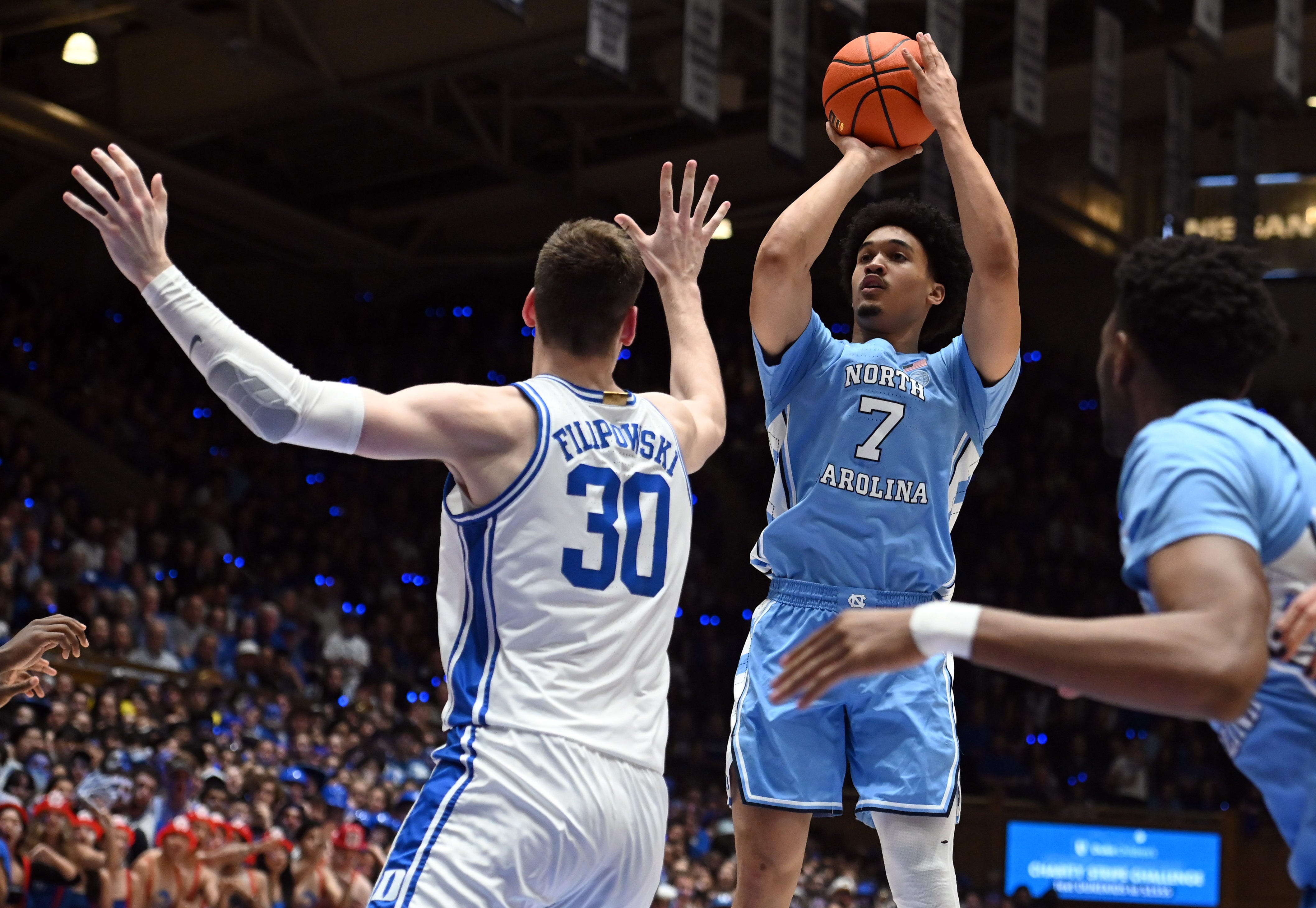 Mar 9, 2024; Durham, North Carolina, USA; North Carolina Tar Heels guard Seth Trimble (7) shoots over Duke Blue Devils center Kyle Filipowski (30) during the first half at Cameron Indoor Stadium. Mandatory Credit: Rob Kinnan-USA TODAY Sports