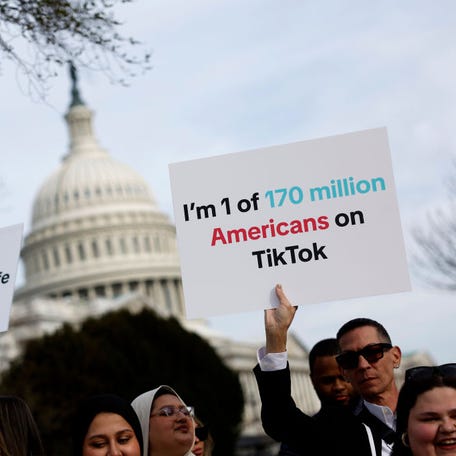 People hold signs in support of TikTok outside the U.S. Capitol Building on March 13, 2024. The House of Representatives voted Wednesday on a bill to ban TikTok in the U.S. due to concerns over personal privacy and national security unless the Chinese-owned parent company ByteDance sells the popular video app.