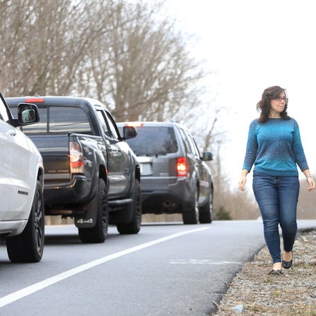 Lia-Marie Henry walks along the shoulder at the intersection of Maloney Road and Noxon Road in LaGrange on March 15, 2024. Henry was rear ended by a Dutchess County Sheriff's deputy, which resulted in her car being totaled.