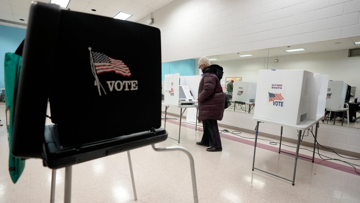 March 19, 2024; Columbus, Ohio, USA;   A woman votes at Blackburn Recreation Center on Election Day on Tuesday.