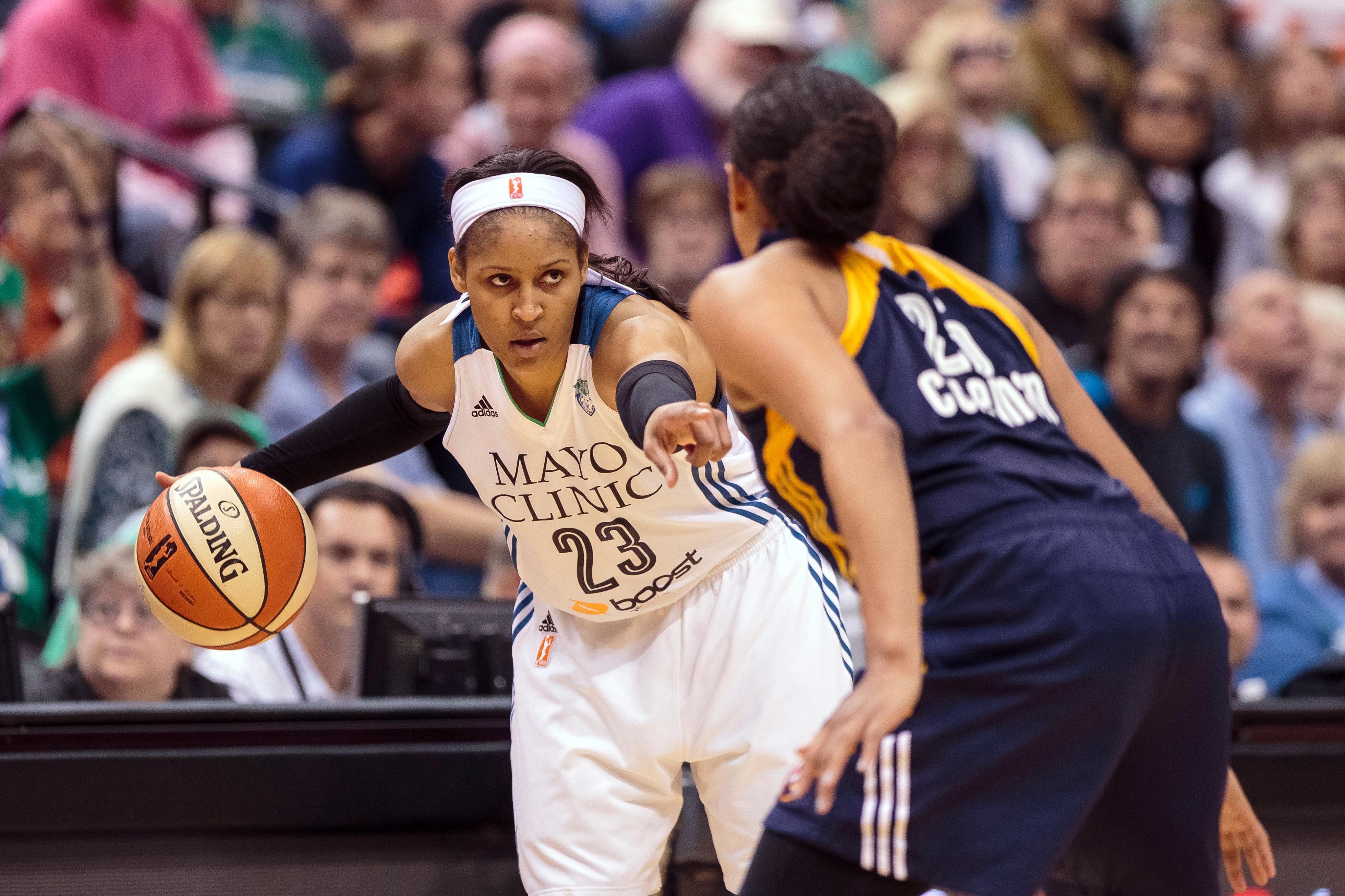 Oct 6, 2015; Minneapolis, MN, USA; Minnesota Lynx forward Maya Moore (23) dribbles in the fourth quarter against the Indiana Fever forward Tamika Catchings (24) at Target Center. Mandatory Credit: Brad Rempel-USA TODAY Sports