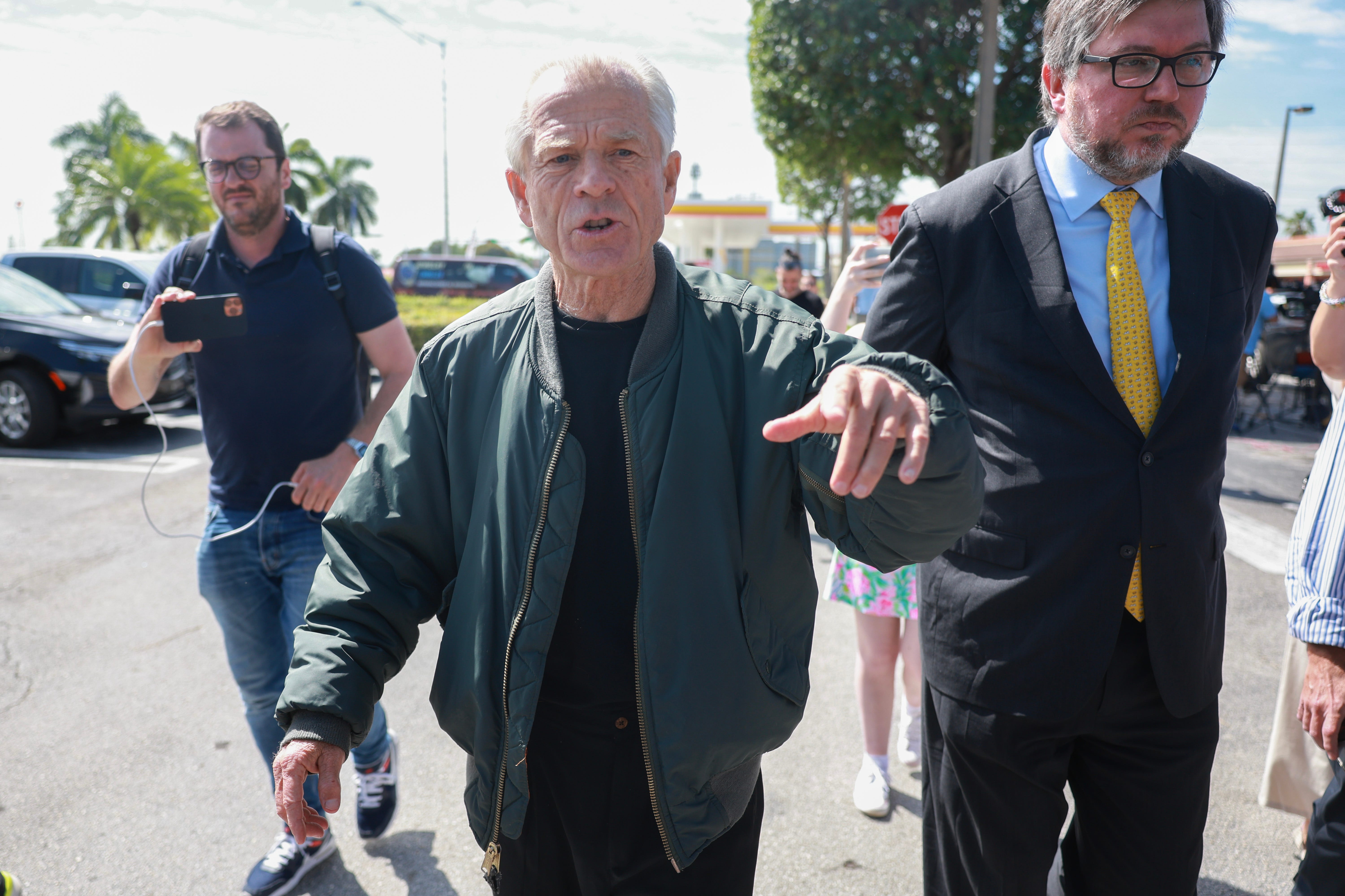 Former Donald Trump adviser Peter Navarro walks away after holding a press conference before turning himself into a federal prison on March 19, 2024, in Miami, Florida. Mr. Navarro, who was convicted of contempt of Congress last year, surrendered at a federal Bureau of Prisons facility to begin serving his four-month sentence after speaking to the media.