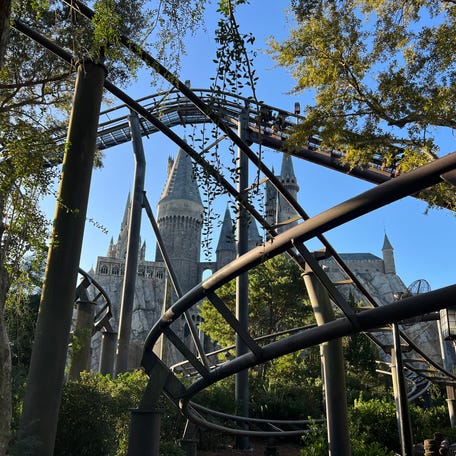 Hogwarts Castle is seen through Flight of the Hippogriff tracks at the Wizarding World of Harry Potter - Hogsmeade at Universal Islands of Adventure.