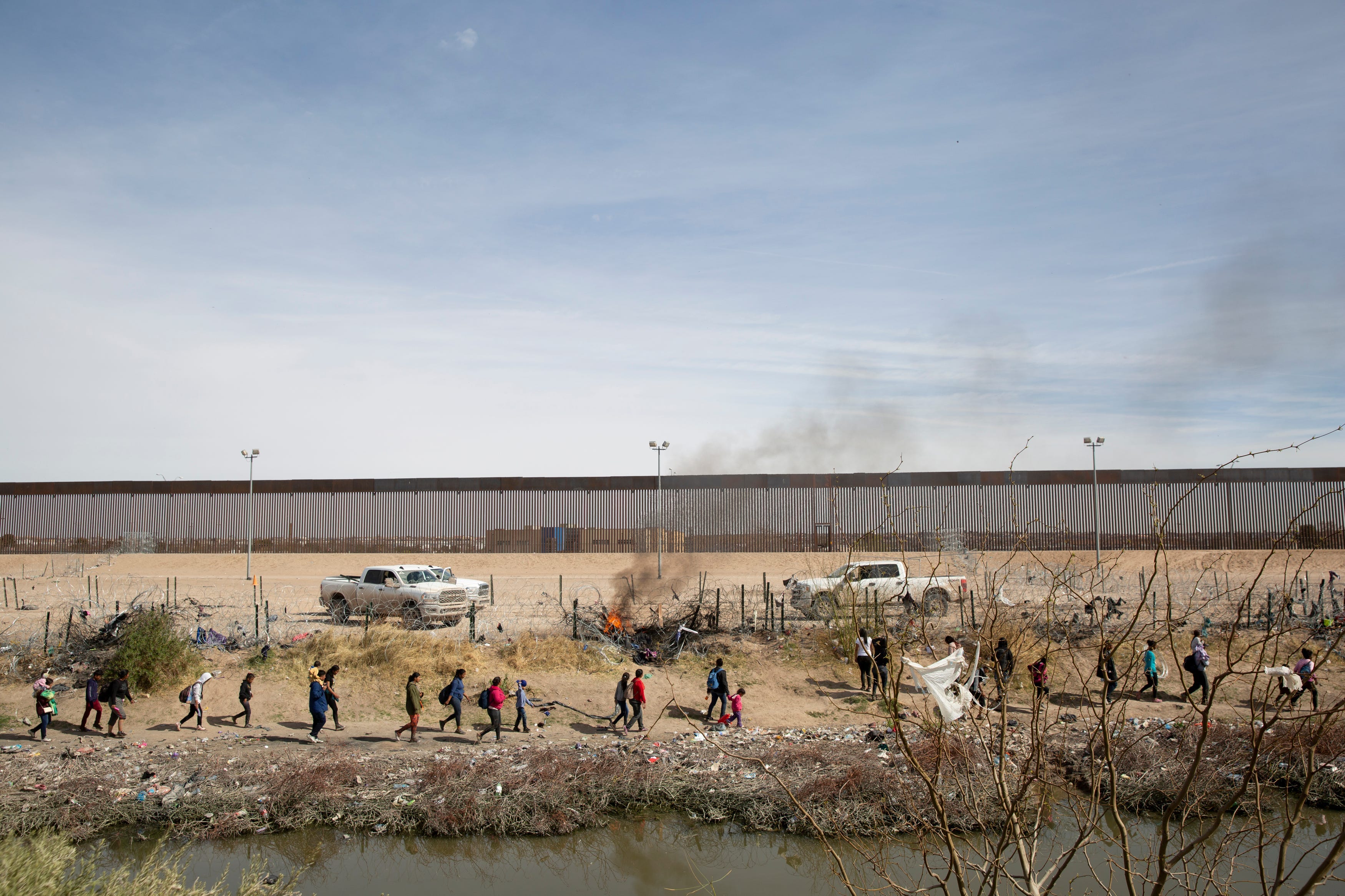 Asylum seekers cross the Rio Grande in El Paso, Texas in hopes of turning themselves in to the Border Patrol for processing on March 6, 2024.