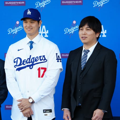 Shohei Ohtani stands next to interpreter Ippei Mizuhara at an introductory press conference at Dodger Stadium.