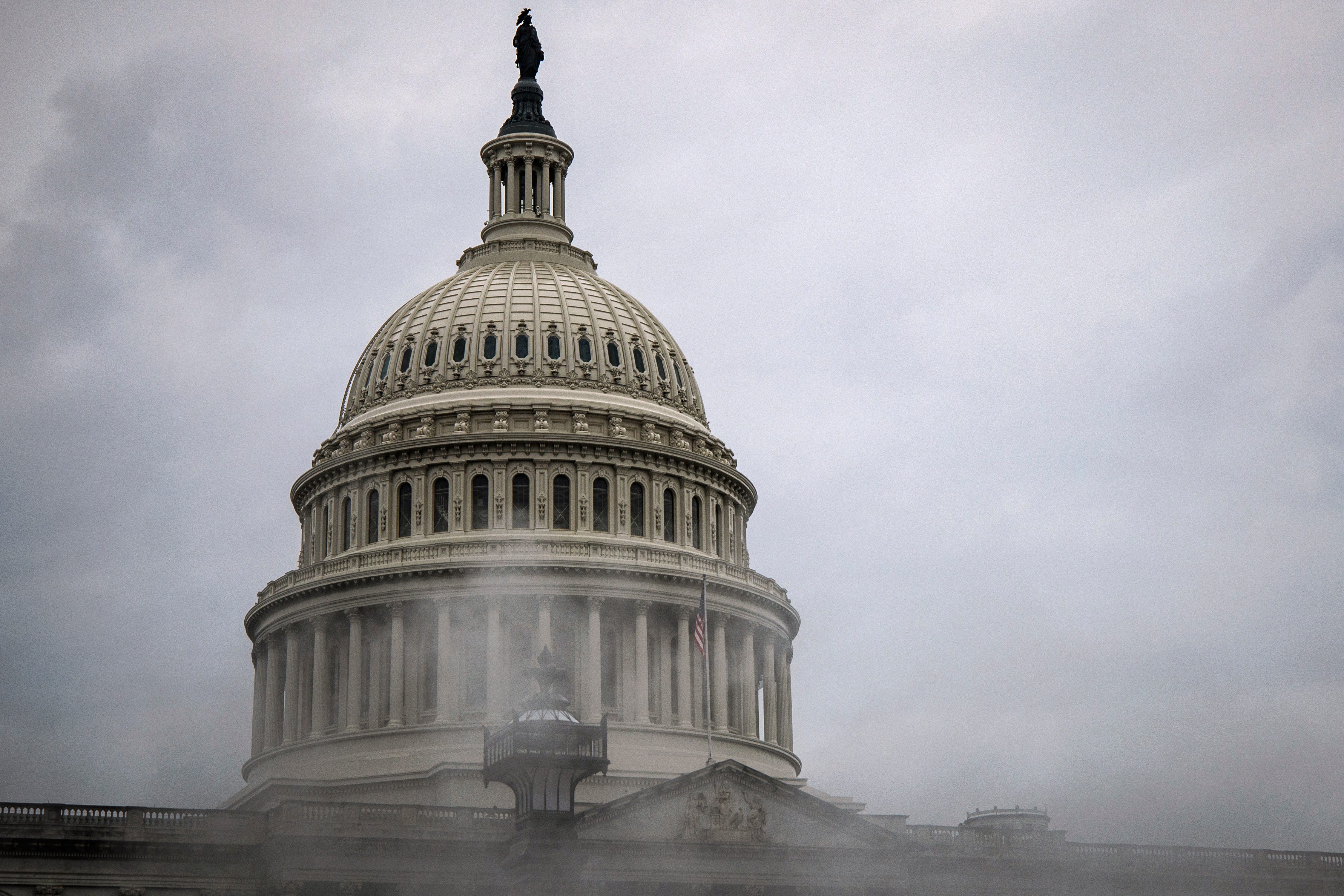 WASHINGTON, DC - FEBRUARY 11: The U.S. Capitol building is seen past a cloud of steam rising from a vent on Capitol Hill on February 11, 2024 in Washington, DC. The Senate is convening for a rare Sunday session to vote on a supplementary spending bill that includes military aid for Ukraine, Israel, and Taiwan without addressing border security after Republicans in the House abandoned an agreement that they initially agreed to. (Photo by Samuel   Corum/Getty Images) ORG XMIT: 776104902 ORIG FILE ID: 1995705993