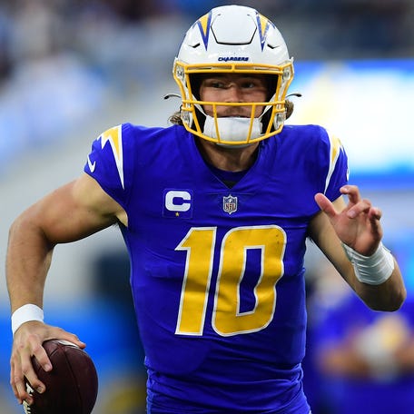 Dec 12, 2021; Inglewood, California, USA; Los Angeles Chargers quarterback Justin Herbert (10) runs the ball against the New York Giants during the second half at SoFi Stadium. Mandatory Credit: Gary A. Vasquez-USA TODAY Sports ORG XMIT: IMAGN-451714 ORIG FILE ID: 20211212_gav_sv5_046.jpg