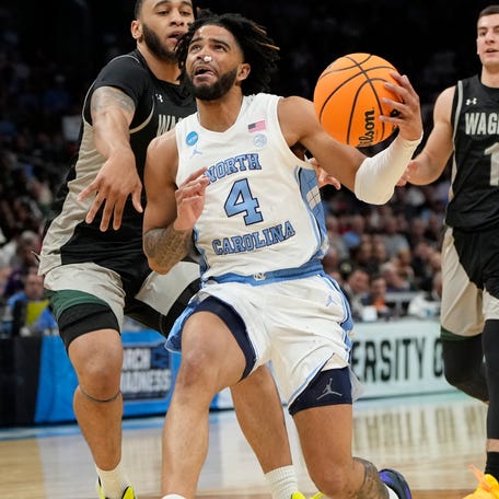 North Carolina guard RJ Davis (4) drives to the basket against Wagner in the first round of the 2024 NCAA men's tournament at the Spectrum Center.