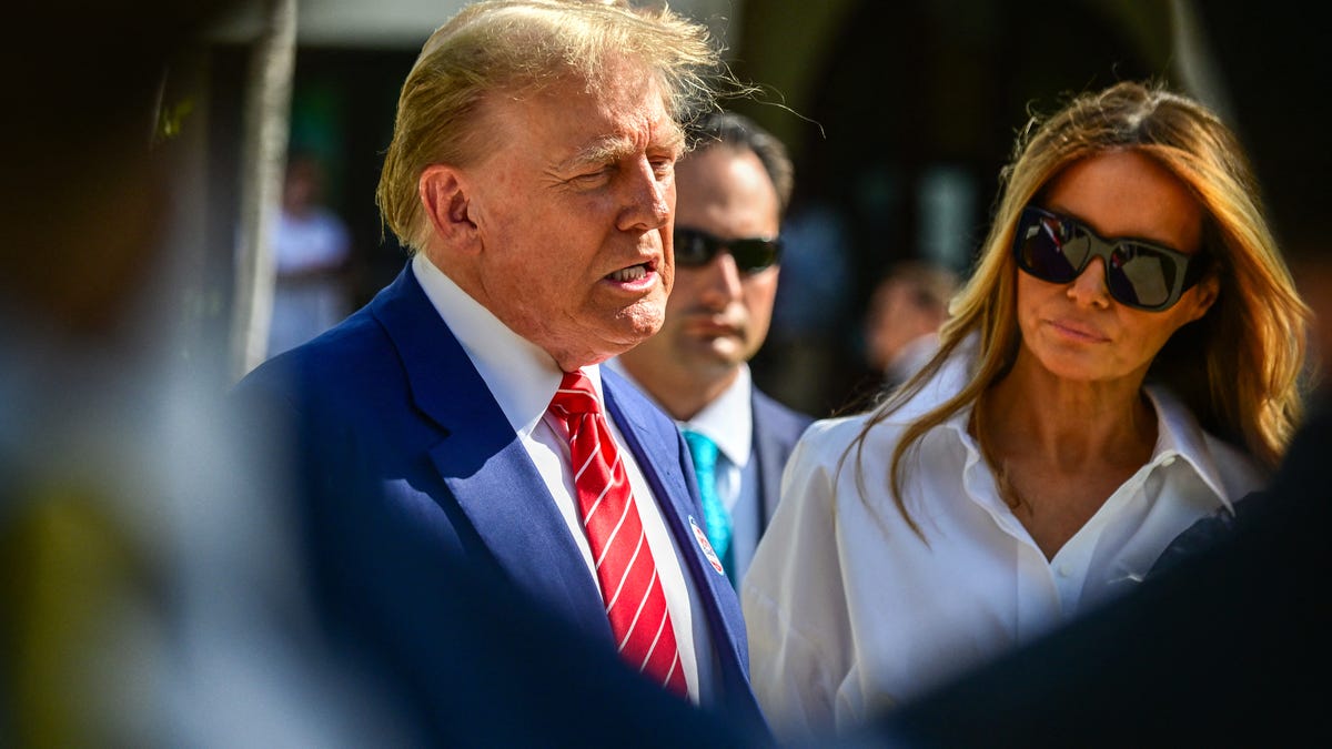 Former US President and Republican presidential candidate Donald Trump (L) and former First Lady Melania Trump arrive to vote in Florida's primary election at a polling station at the Morton and Barbara Mandel Recreation Center in Palm Beach, Florida, on March 19, 2024.
