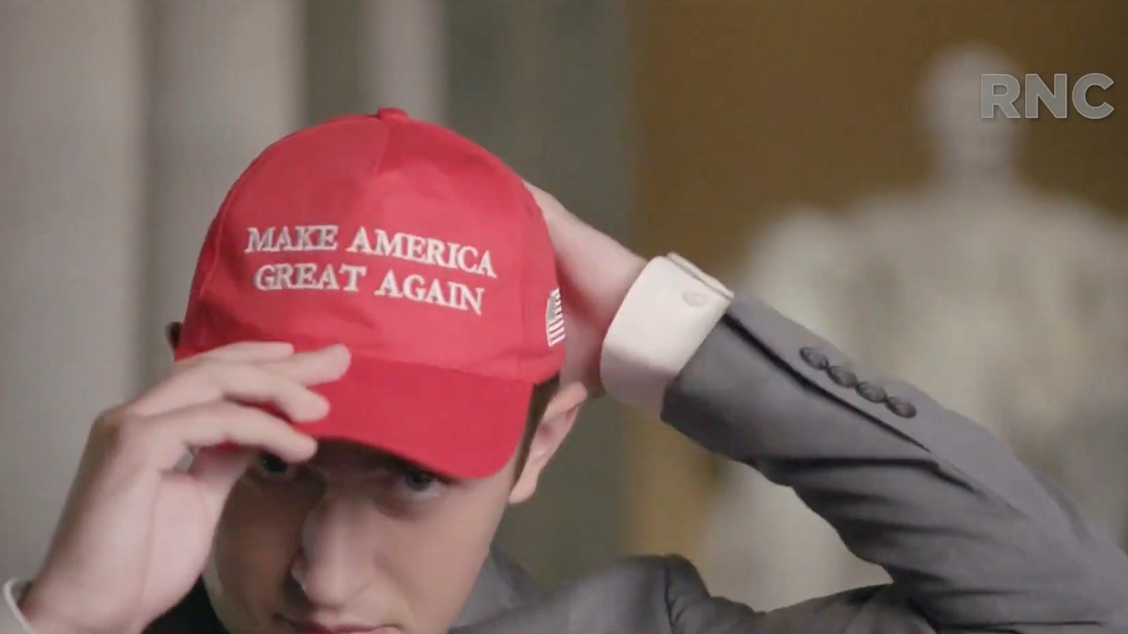Former Covington Catholic High School Student Nicholas Sandmann puts on a Make America Great Again hat while he speaks by video feed as the Lincoln Memorial is seen in the background during the 2020 Republican National Convention on Aug. 25, 2020.