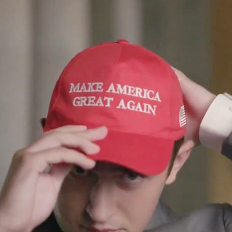 Former Covington Catholic High School Student Nicholas Sandmann puts on a Make America Great Again hat while he speaks by video feed as the Lincoln Memorial is seen in the background during the 2020 Republican National Convention on Aug. 25, 2020.