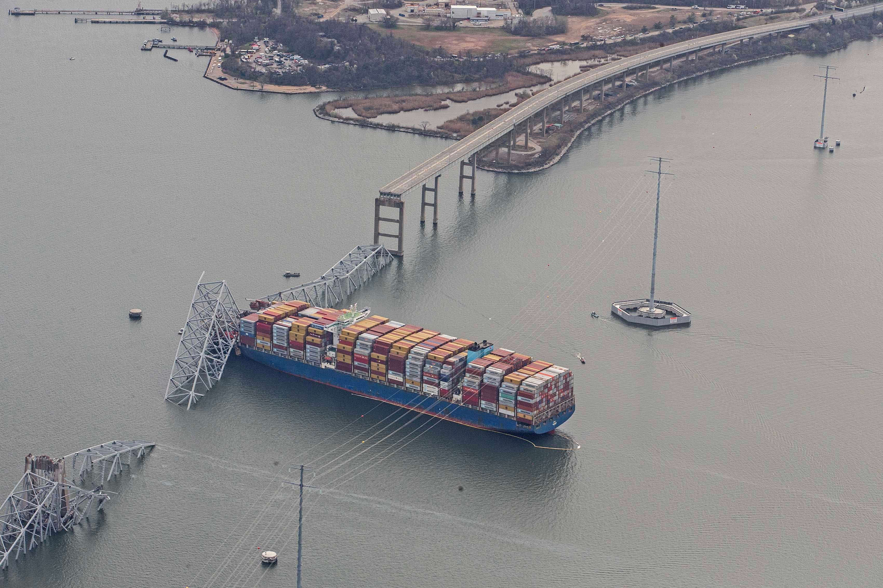 The container ship Dali is shown amidst the wreckage of the collapsed Francis Scott Key Bridge in Baltimore, Tuesday, March 26, 2024. Six people are missing after the Dali lost power and crashed into one of the bridge's support columns.