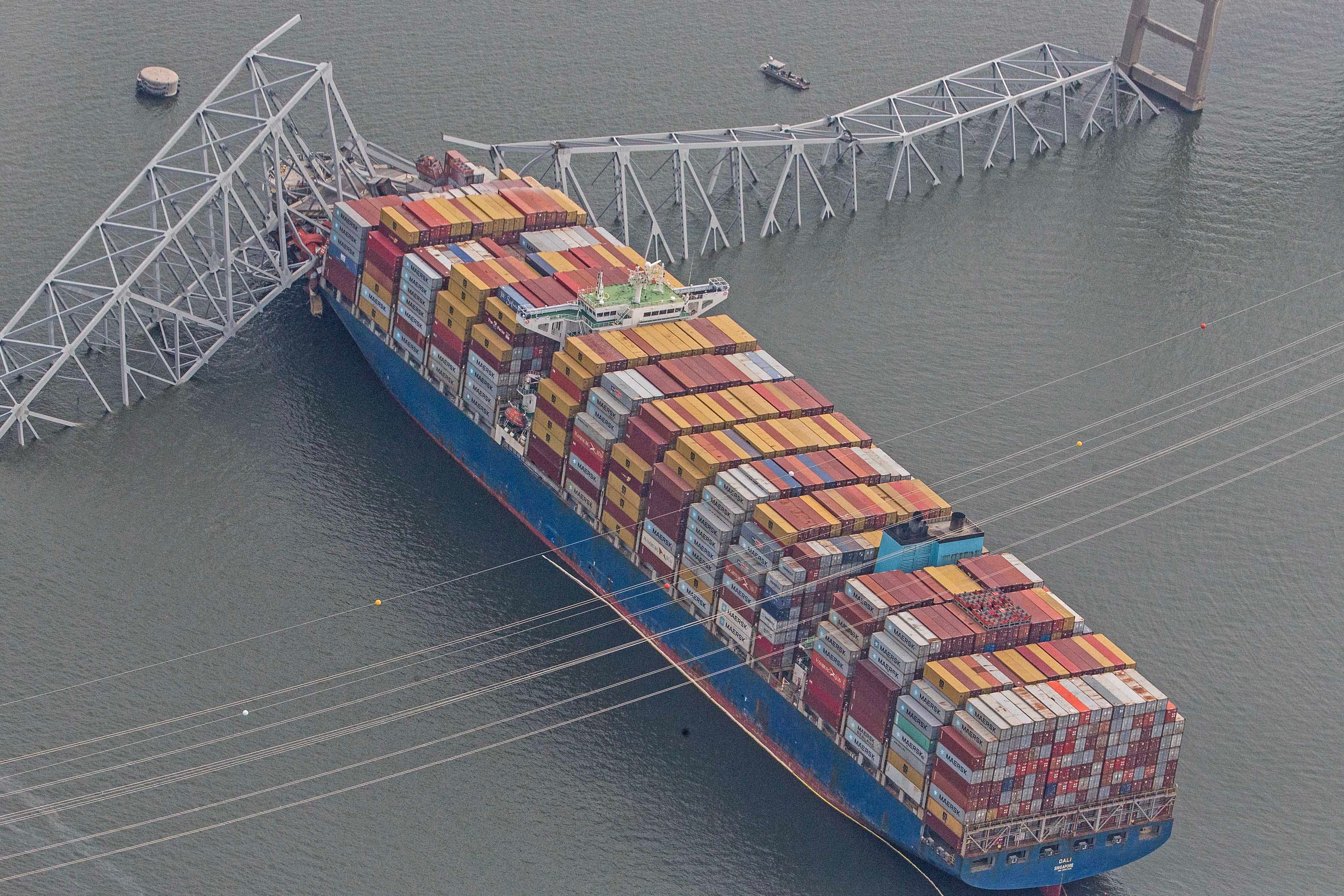 The container ship Dali is shown amidst the wreckage of the collapsed Francis Scott Key Bridge in Baltimore, Tuesday, March 26, 2024. Six people are missing after the Dali lost power and crashed into one of the bridge's support columns.